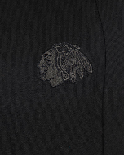 black lululemon joggers with tonal Chicago Blackhawks primary logo embroidered on left leg - detail lay flat