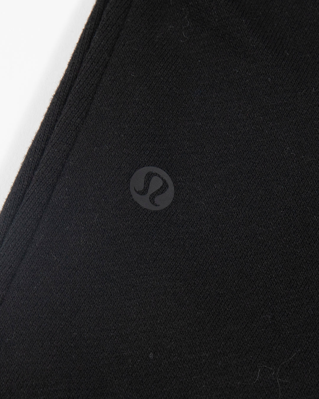 black lululemon joggers with tonal Chicago Blackhawks primary logo embroidered on left leg - alt detail lay flat