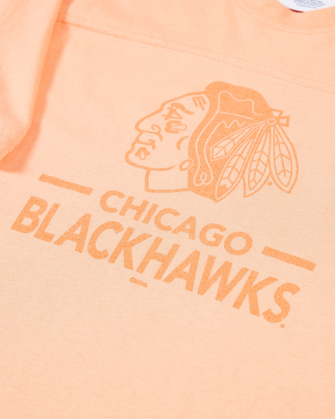 peach Champion cropped tee with Chicago Blackhawks primary logo and wordmark across the chest - detail lay flat