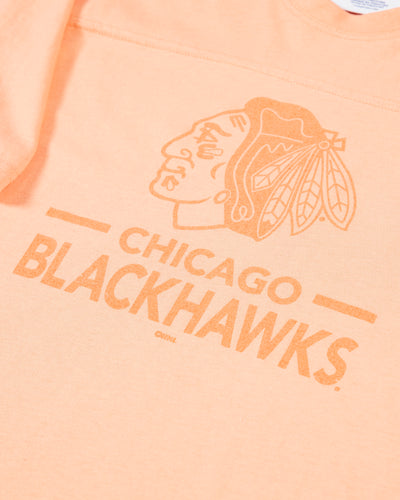 peach Champion cropped tee with Chicago Blackhawks primary logo and wordmark across the chest - detail lay flat