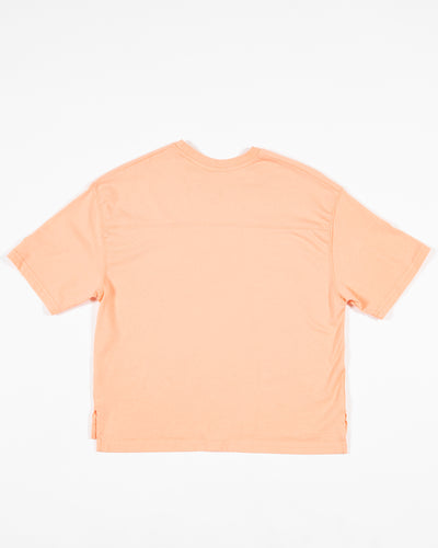 peach Champion cropped tee with Chicago Blackhawks primary logo and wordmark across the chest - back lay flat