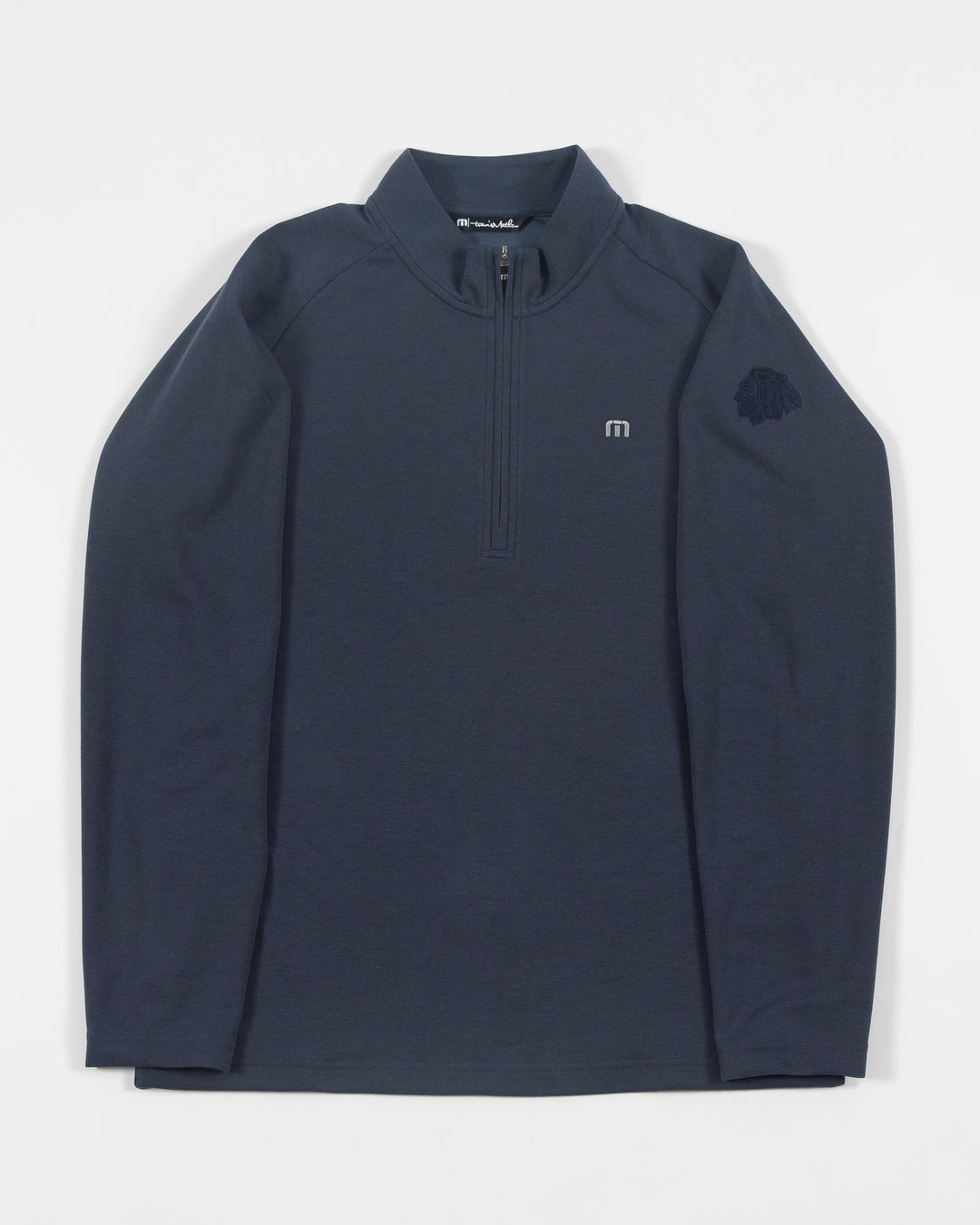 navy TravisMathew quarter zip with Chicago Blackhawks primary logo embroidered on left shoulder - front lay flat