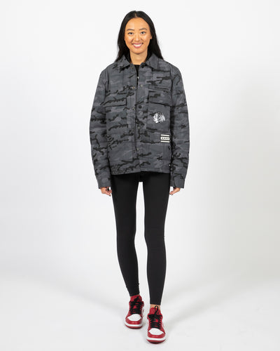 Wild Collective oversized camo print zip up jacket with Blackhawks primary logo and Chicago flag on front and Chicago Blackhawks on back - front view zipped